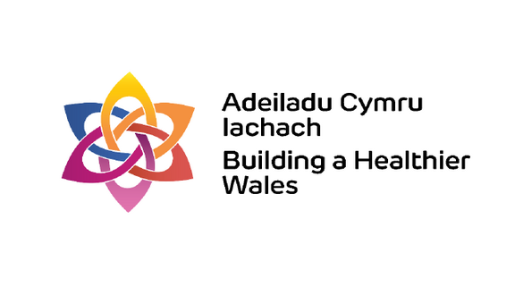 Logo for Building a Healthier Wales: a colorful interwoven star/icon to the left with the bilingual text 'Adeiladu Cymru...' and 'Building a Healthier Wales' to the right.