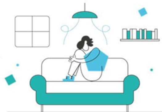 Person sitting on a teal couch, hugging knees, in a living room with a lamp and bookshelf.